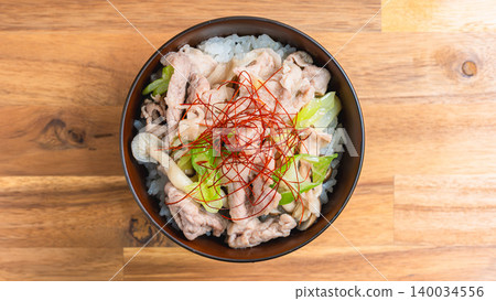 Green onion and salt pork bowl: A photo of a Japanese-style rice bowl with pork and mushrooms topped with shredded chili peppers. Green onion and salt pork bowl: A photo of a Japanese-style rice bowl with pork and mushrooms topped with shredded chili peppers. 140034556