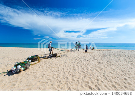 SRI LANKA - Mach 23: Local fishermen pull a fishing net from Indian Ocean on Mach 23, 2017 in Kosgoda, Sri Lanka. Fishing in Sri Lanka is the way they earn their living. 140034698
