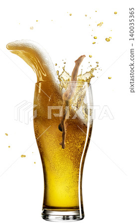 Female dancer splashing into tall beer glass with foam wave and droplets. Female dancer splashing into tall beer glass with foam wave and droplets. 140035365