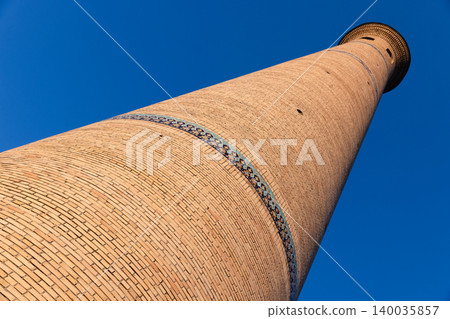 Dramatic low-angle perspective of a tall brick minaret tower Dramatic low-angle perspective of a tall brick minaret tower 140035857