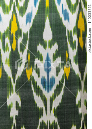Colorful handwoven ikat textile featuring bold motifs 140035861
