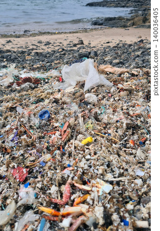Plastic waste and microplastics cover the beach, causing severe ecological damage to marine life and coastlines Plastic waste and microplastics cover the beach, causing severe ecological damage to marine life and coastlines 140036405