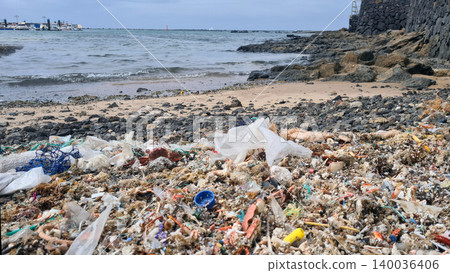 Plastic waste and microplastics cover the beach, causing severe ecological damage to marine life and coastlines Plastic waste and microplastics cover the beach, causing severe ecological damage to marine life and coastlines 140036406