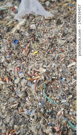 Plastic waste and microplastics cover the beach, causing severe ecological damage to marine life and coastlines 140036407