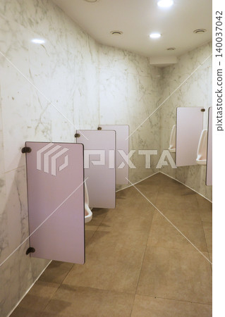 Men's restroom with partitions between urinals Men's restroom with partitions between urinals 140037042
