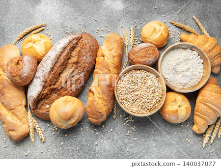 Assortment of fresh baked bread, grain, and flour Assortment of fresh baked bread, grain, and flour 140037077