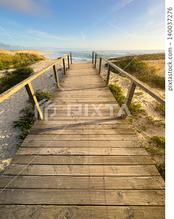 Vertical Perspective of Wooden Boardwalk at Sunset on Furadouro Beach in Portugal Vertical Perspective of Wooden Boardwalk at Sunset on Furadouro Beach in Portugal 140037276