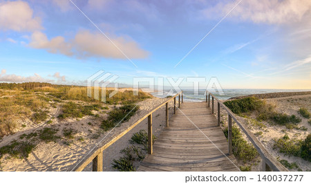 Wooden Boardwalk Leading to the Atlantic Coast at Furadouro Beach in Ovar Portugal Wooden Boardwalk Leading to the Atlantic Coast at Furadouro Beach in Ovar Portugal 140037277