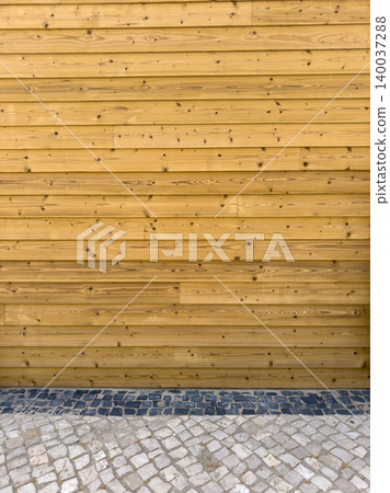Horizontal wooden plank wall siding with cobblestone ground Horizontal wooden plank wall siding with cobblestone ground 140037288