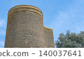 Maiden Tower or Qiz Qalasi, iconic 12th century monument in Old City, Icherisheher of Baku, Azerbaijan. Blue sky and olive tree on background, copy space. Traveling and tourism, famous spots 140037641