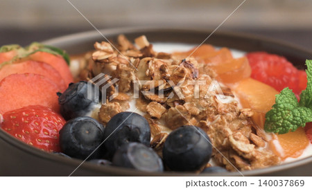 Yogurt with baked granola and berries Yogurt with baked granola and berries 140037869