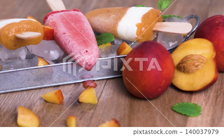 Homemade Peach and Berry Fruit Popsicles on Ice with Fresh Nectarines 140037979
