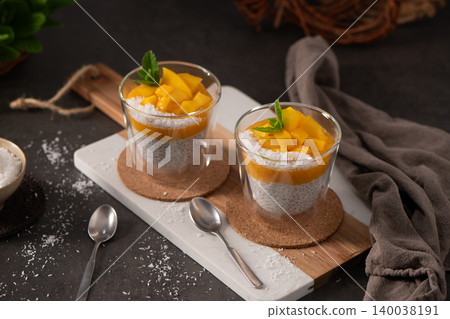 Mango Chia Seed Pudding with Coconut and Fresh Mint in Glass Cups Mango Chia Seed Pudding with Coconut and Fresh Mint in Glass Cups 140038191