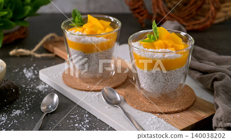 Mango Chia Seed Pudding with Coconut and Mint in Glass Jars Mango Chia Seed Pudding with Coconut and Mint in Glass Jars 140038202