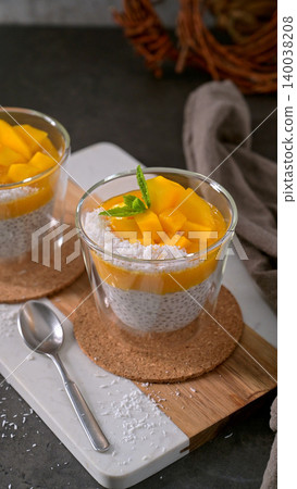 Mango Chia Seed Pudding with Coconut and Mint in Glass Jars Mango Chia Seed Pudding with Coconut and Mint in Glass Jars 140038208