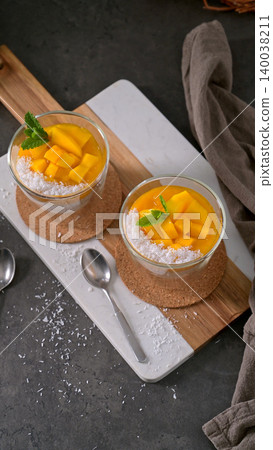 Two Glasses of Mango Chia Seed Pudding with Coconut and Mint 140038211