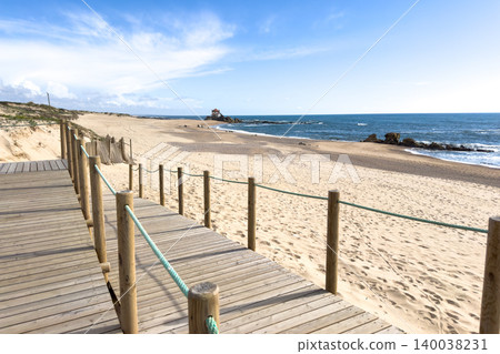 Wooden Boardwalk at Miramar Beach Overlooking the Atlantic and Senhor da Pedra Chapel Wooden Boardwalk at Miramar Beach Overlooking the Atlantic and Senhor da Pedra Chapel 140038231