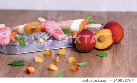 Homemade raspberries and peach popsicles Homemade raspberries and peach popsicles 140038704