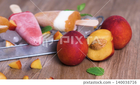 Homemade raspberries and peach popsicles 140038716