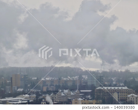 Heavy smoke obscures factories and rooftops widely. Polluted air clouds urban view and affects environment 140039380