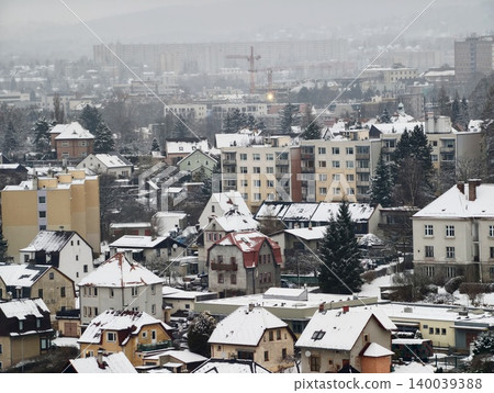 Urban winter scene. Winter city environment with muted yellow facades and highrise structures Urban winter scene. Winter city environment with muted yellow facades and highrise structures 140039388