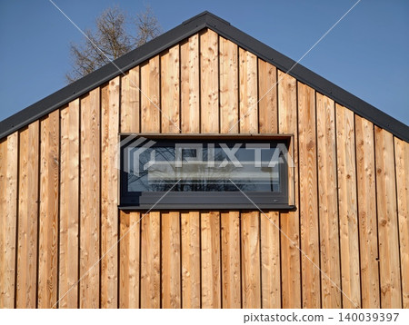 Modern wooden exterior. Scandinavianinspired structure featuring horizontal planks and clean lines Modern wooden exterior. Scandinavianinspired structure featuring horizontal planks and clean lines 140039397