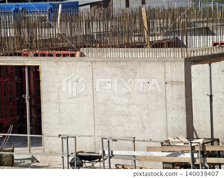 Early phase of building process displaying uncompleted concrete skeleton and supportive reinforcements Early phase of building process displaying uncompleted concrete skeleton and supportive reinforcements 140039407
