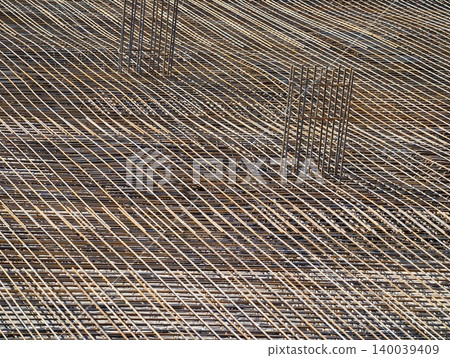 Sunlit metal with geometric shadows. Architectural detail reveals linear rebar and shadow interplay Sunlit metal with geometric shadows. Architectural detail reveals linear rebar and shadow interplay 140039409