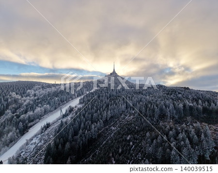 Skyline with tower. Golden light highlights silhouette of tower atop hill with dramatic sky scene 140039515