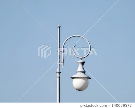 Historical style lamppost displaying ornate details and subtle twilight ambiance suitable for urban narratives Historical style lamppost displaying ornate details and subtle twilight ambiance suitable for urban narratives 140039572