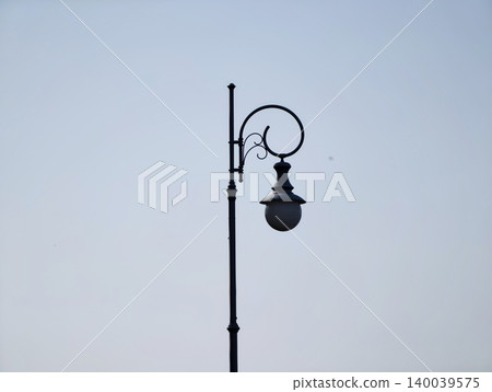 Dark street scene with stark shadows. Moonlit cityscape highlighting shadows and solitary mood Dark street scene with stark shadows. Moonlit cityscape highlighting shadows and solitary mood 140039575