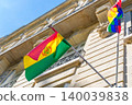 Bolivian flag swaying in the wind against blue sky and historical buildings. Bolivia and Wiphala flags. Flag day celebration concept, patriotism concept. Embassies and consulates of countries 140039838