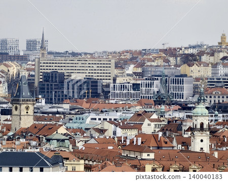 Cityscape with rooftops and spires. Elevated view of dense city rooftops and distant horizon 140040183