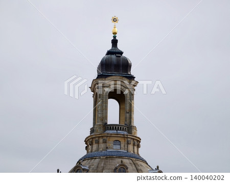 Decorative dome with golden details. Ornate dome featuring lantern finial and textured stucco surface 140040202