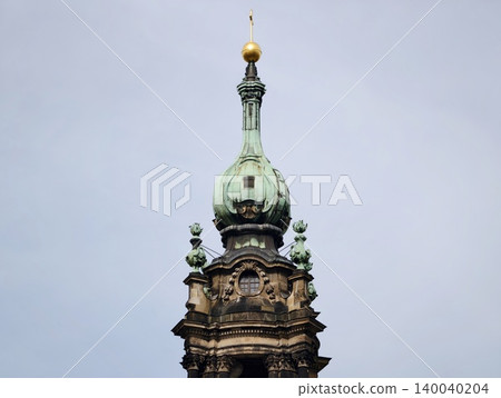 Decorative spire exists. Elaborate steeple with gilded accents under cloudy sky and ringing bell Decorative spire exists. Elaborate steeple with gilded accents under cloudy sky and ringing bell 140040204