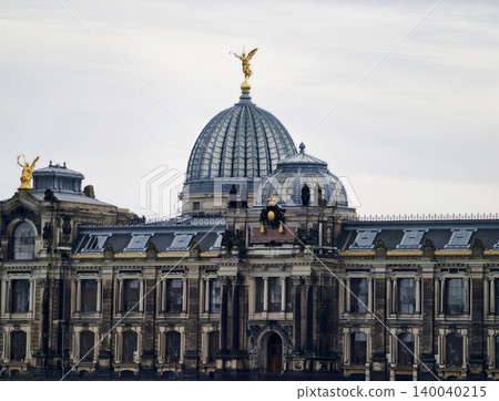 Decorative angel dome. Highly detailed image featuring gilded angel statue on ornate copperdomed building Decorative angel dome. Highly detailed image featuring gilded angel statue on ornate copperdomed building 140040215