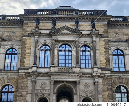 Grand classical building design. Ornate neoclassical facade featuring detailed sculptures and arches Grand classical building design. Ornate neoclassical facade featuring detailed sculptures and arches 140040247