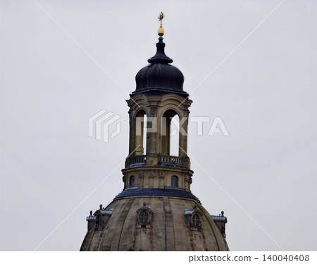 Dome towers skyward. Old majestic tower with detailed stonework and atmospheric city surroundings Dome towers skyward. Old majestic tower with detailed stonework and atmospheric city surroundings 140040408