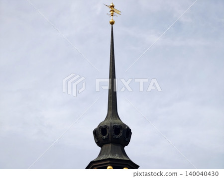 Moodily lit towering spire. Sleek vertical monument with hidden lighting effects and mysterious aura Moodily lit towering spire. Sleek vertical monument with hidden lighting effects and mysterious aura 140040430