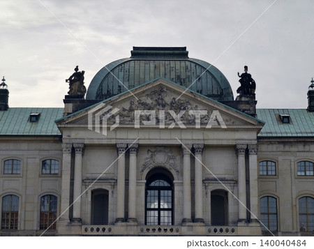Symmetric historic front with detailed sculptures beneath overcast sky captured distinctly Symmetric historic front with detailed sculptures beneath overcast sky captured distinctly 140040484