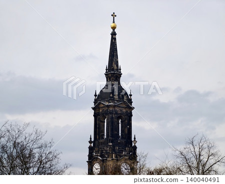 Lofty slender spire piercing through thick cloudy atmosphere creating striking visual contrast 140040491