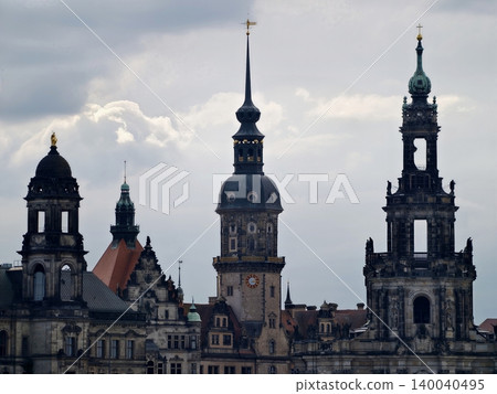 Skyscrapers and domes in dramatic cityscape. Photograph of ancient towers under moody overcast sky 140040495