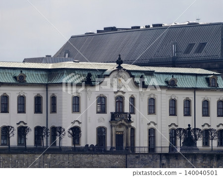 Timeless classical edifice situated by peaceful river with overcast skies and subdued tones 140040501