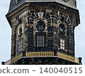 Decorative historic timepiece structure. Weathered monument featuring intricate balcony details 140040515