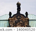Decorative rooftop emblem. Ornamental rooftop detail featuring bronze textures and sculpted figures 140040520
