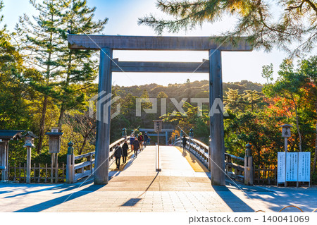 Ise Grand Shrine's Inner Shrine: The Uji Bridge Torii gate illuminated by the morning sun. Ise Grand Shrine's Inner Shrine: The Uji Bridge Torii gate illuminated by the morning sun. 140041069