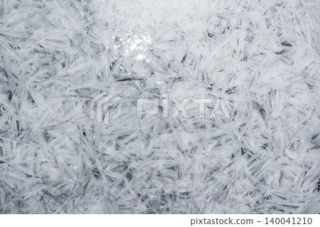 Sharp, glistening river ice shards form an intricate frozen tapestry. This chilly abstract pattern showcases nature's delicate artistry on a cold winter's day Sharp, glistening river ice shards form an intricate frozen tapestry. This chilly abstract pattern showcases nature's delicate artistry on a cold winter's day 140041210