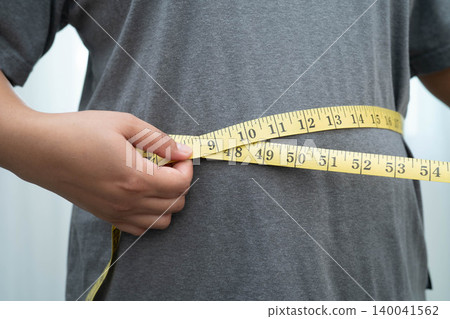 Asian woman with fat belly big size overweight and obesity with measure tape. Asian woman with fat belly big size overweight and obesity with measure tape. 140041562