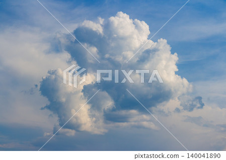 Fluffy white cumulus cloud floating in the clear blue sky, a majestic bright heaven formation capturing the pure summer atmosphere and peaceful serenity of a sunny bright day Fluffy white cumulus cloud floating in the clear blue sky, a majestic bright heaven formation capturing the pure summer atmosphere and peaceful serenity of a sunny bright day 140041890