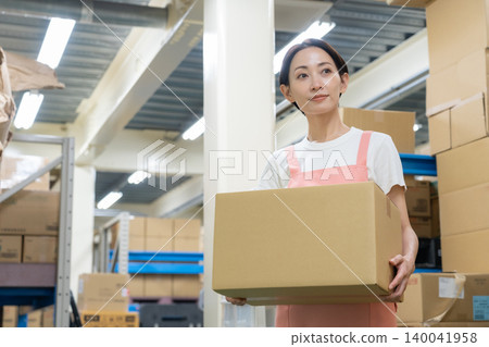 Middle-aged woman working in a warehouse Middle-aged woman working in a warehouse 140041958